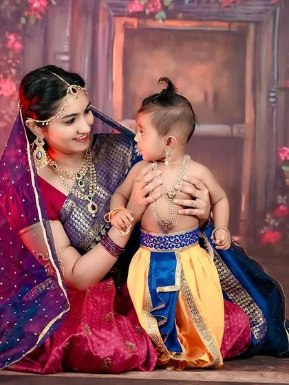 The timeless love of Yashoda and her little Krishna. We created this beautiful themed portrait to celebrate a mother's bond, using traditional attire and a rich, floral backdrop to bring the story to life.