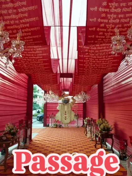 This traditional red passage is personalized with Sanskrit verses printed on the ceiling drapes. The crystal chandeliers and red fabric walls create a deeply spiritual and visually stunning entrance.