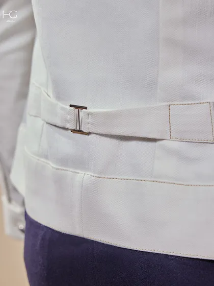 The back detail of the white shacket, featuring an adjustable strap for a perfect fit. It's these thoughtful details that define my work.
