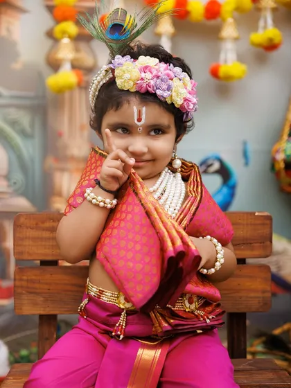 A playful little Krishna with a flute, giving a cheeky look to the camera. These are the moments I love to capture.