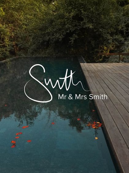 A branded image celebrating our listing with Mr & Mrs Smith, featuring the serene pool with floating petals.