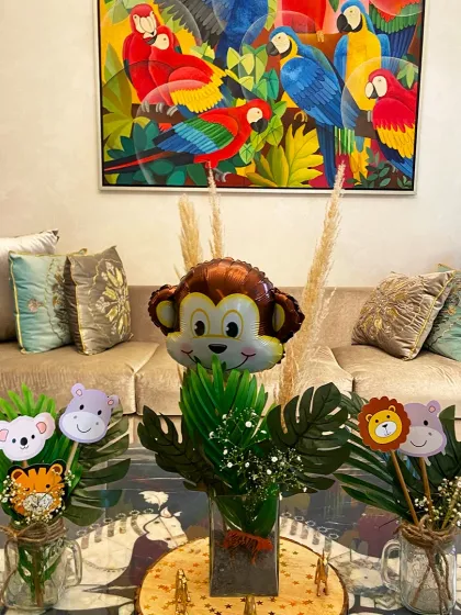 It's all in the details. These cute animal-themed centerpieces, complete with a monkey balloon and character sticks, add a playful touch to the tables at our jungle safari party.
