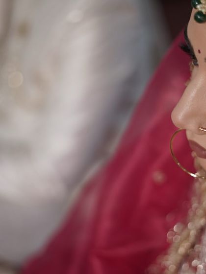 A candid shot during the ceremony. The makeup is soft and natural, focusing on enhancing her features for a timeless and elegant look.