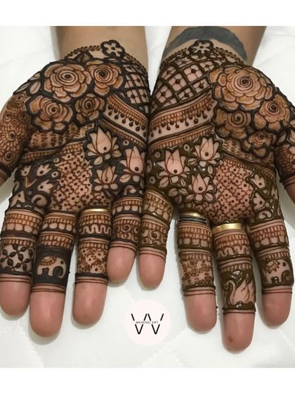 The front of the hands, featuring a mix of roses, lotuses, swans, and baby elephants.