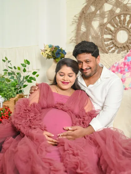 The gentle touch on the baby bump says it all. This cozy indoor maternity photo captures the deep love and anticipation of the parents to be.