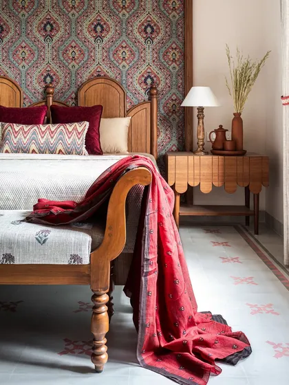 The grandparents' room is an ethnic retreat where patterns galore. A fabric panel with a deep red and blue Indian motif makes a statement behind the headboard, while custom cement tiles with red motifs tie the whole look together beautifully.