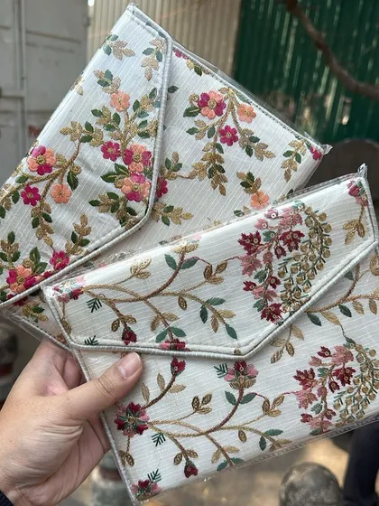 Two beautiful envelope clutches with different floral embroidery patterns. These are lightweight and just the right size for your phone and lipstick.