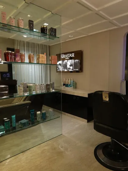 A look at our men's grooming section, featuring premium products and a classic barber chair for a sophisticated and comfortable experience.