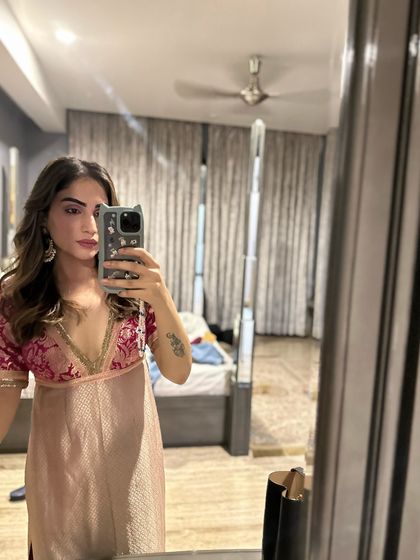 A mirror selfie showing a brocade top I designed. I often mix and match my self-designed pieces to create new looks.