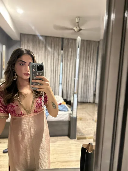 A mirror selfie showing a brocade top I designed. I often mix and match my self-designed pieces to create new looks.