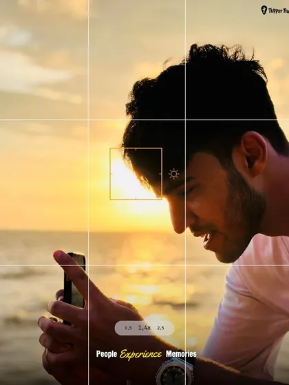 A traveler captures a beautiful sunset on his phone. This image represents the importance of capturing and cherishing the perfect moments on our trips.