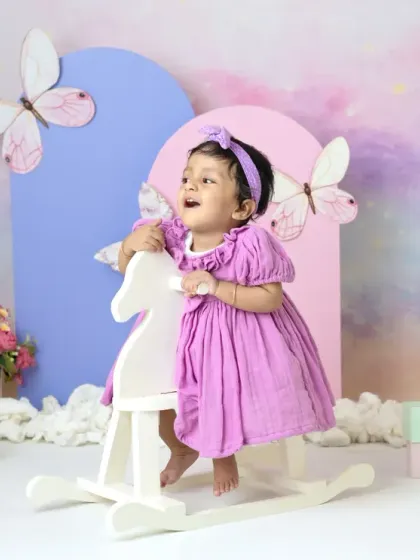 A magical unicorn and butterfly theme for a first birthday. The pastel colors, whimsical props, and dreamy backdrop create a true fairy tale setting.