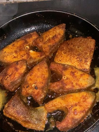 Frying up some fish steaks for the day's orders.
