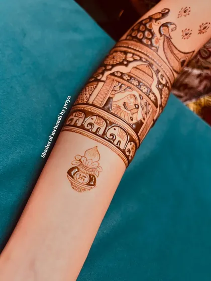 The lower part of the arm design, featuring a sacred kalash, adding another layer of tradition to the wedding story mehendi.
