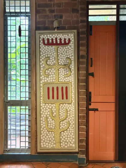 A decorative panel next to a doorway, featuring a traditional motif made with inlaid materials. This kind of detailed craftsmanship adds a layer of meaning and beauty to everyday spaces.