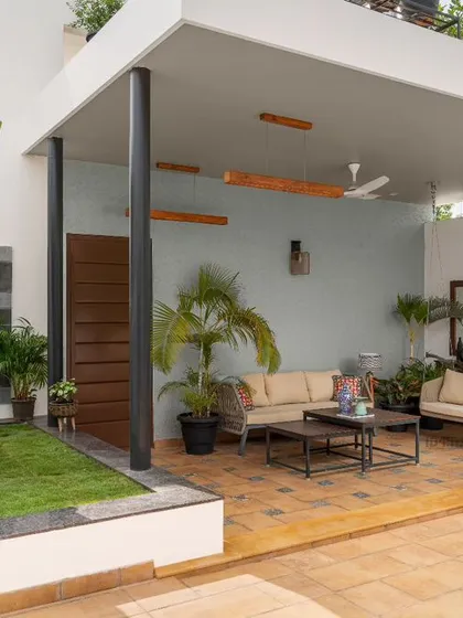 We transformed this terrace into a serene outdoor lounge. The design provides a covered seating area for relaxation, surrounded by lush greenery, creating a perfect escape with views of the Bangalore skyline.