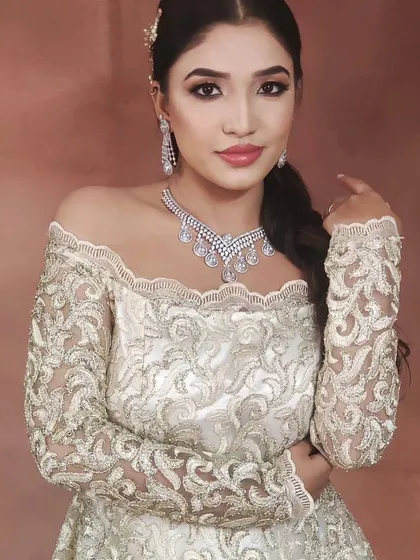 A portrait of a model wearing the ivory off-shoulder gown, showing how beautifully it photographs. It's available to rent for your pre-wedding or party shoot.