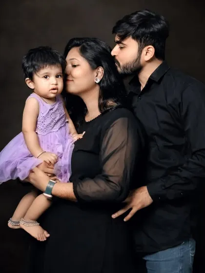 For a more classic and dramatic feel, we use a dark backdrop in our studio. This technique creates a powerful contrast that highlights the emotion and connection between family members, resulting in a timeless, artistic portrait.