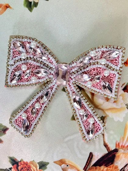 This pink embellished bow is perfect for a fun, flirty, and glamorous hairstyle.