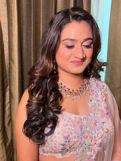 My bride Vini, looking beautiful for her reception in a pastel floral lehenga with soft, romantic makeup.