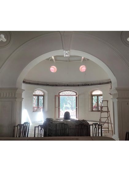 The central hall taking shape, with the archways and pillars newly plastered. Light filters in through the original windows, hinting at the bright, airy space it will become once the historic restoration is complete.