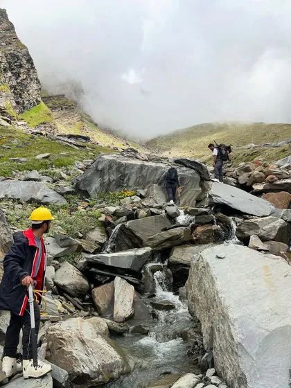 Navigating a rocky stream crossing on the way to Friendship Peak. The terrain is varied and challenging.