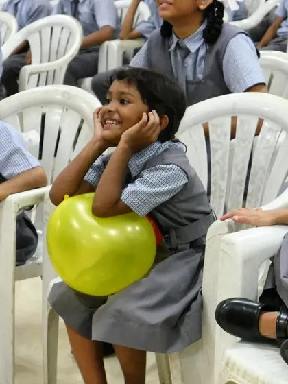 A young girl watches the performance with a look of pure enchantment. These are the moments of wonder we strive to create, where a child can forget their worries and get lost in a story.