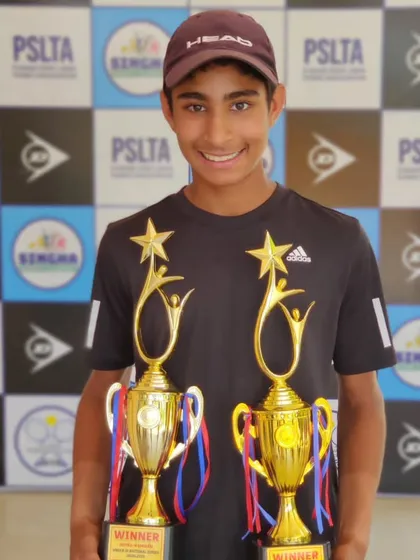 A smiling Tavish with his singles and doubles trophies from the Under 14 National Series in Jalandhar.