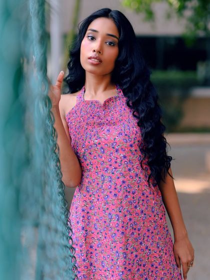 A close-up shot that captures the model's gentle expression and the soft colors of the dress.
