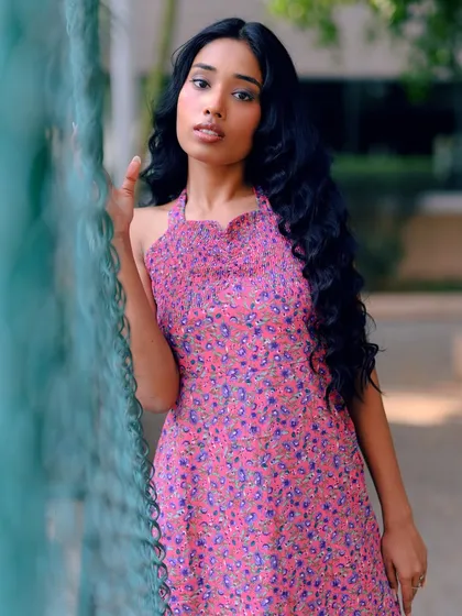 A close-up shot that captures the model's gentle expression and the soft colors of the dress.