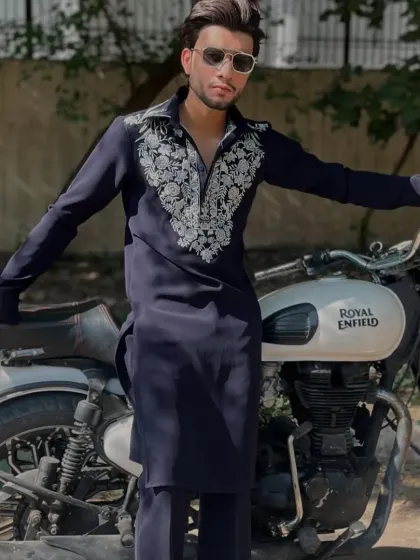 The navy blue kurta styled with a motorcycle for a cool, edgy look.