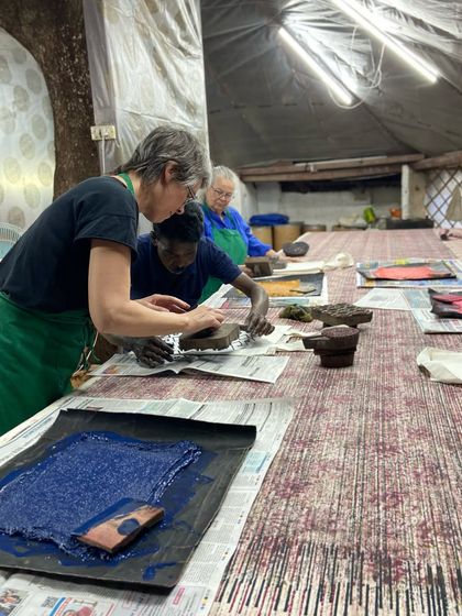 Learning the art of block printing is a hands-on affair. A participant in our workshop with Selvedge Magazine gets personal instruction on applying the right pressure and technique for a clean print.