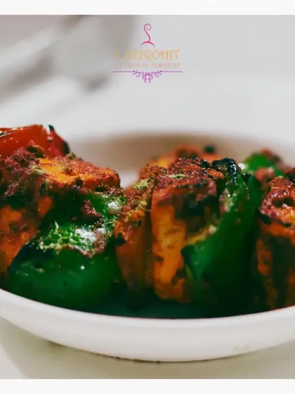 A close-up of my classic Paneer Tikka, marinated in spices and grilled with chunks of bell pepper and onion. It’s a timeless starter that I prepare with authentic flavors.