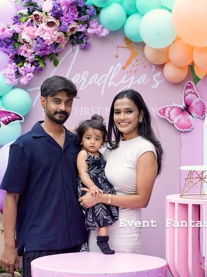 A lovely family photo at Aaradhya's butterfly party, posing in the custom-designed photo booth.