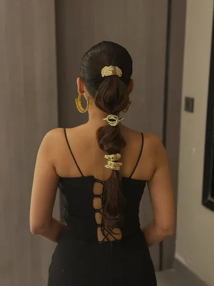 A full view of the accessorized ponytail, showing how it creates a bold statement from the back.