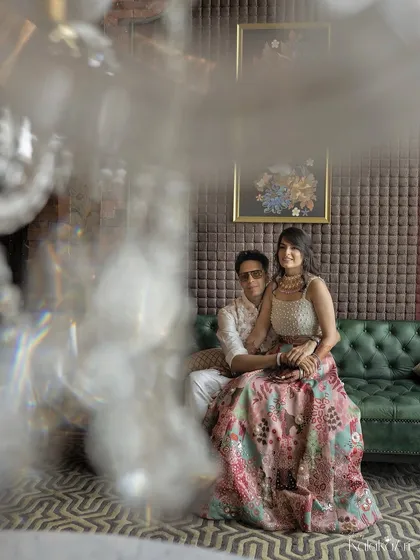 A creative portrait shot through a crystal chandelier, adding a dreamy and glamorous effect. This technique creates a one-of-a-kind image.