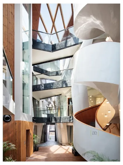 This is the heart of the Cleft House, an award-winning project where we explored the idea of a home as a sculpted monolith. The central atrium, with its helical staircase, is designed to draw in light and connect all levels of the home, creating a dynamic interplay of shared and private spaces.