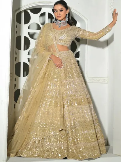 A full-length view of the glamorous all-gold sequin lehenga. This is the ultimate party outfit, available for rent for your most special occasions.