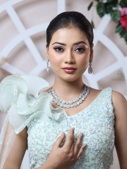 New age minimal glam. This look features clean lines, a sleek ponytail, and makeup that is both understated and striking, perfect for the modern bride.