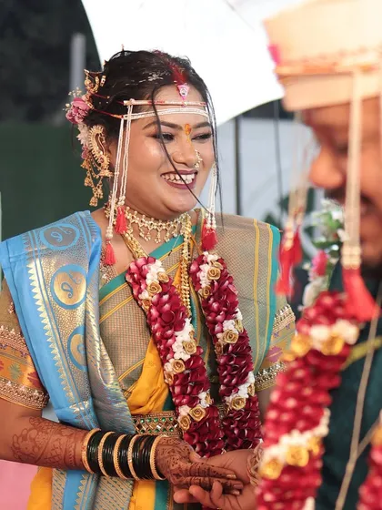 A candid shot of the bride smiling during her wedding ceremony. The makeup is natural and enhances her happy glow.
