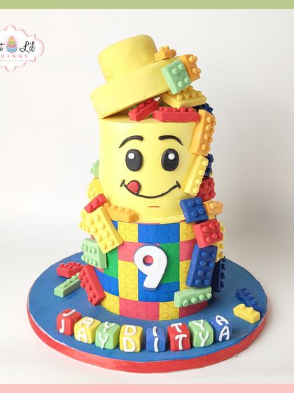 We built this city on fun and frosting! A vibrant LEGO head cake, overflowing with colorful edible blocks, is a fantastic and creative choice for a 9th birthday party.