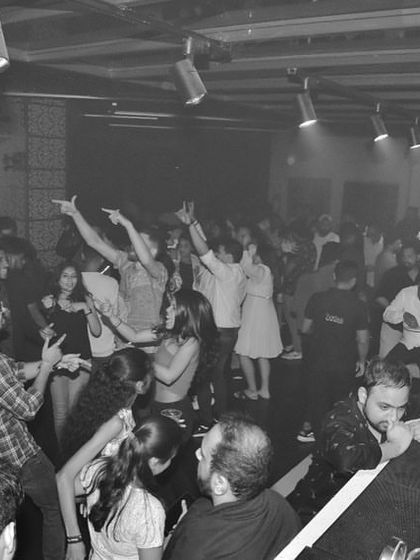 A black and white shot capturing the raw energy of the dance floor. Even without color, the vibe is undeniable.
