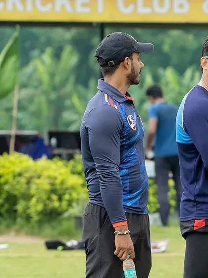 On the field with the team during a practice match. Observing and analyzing every aspect of the game.