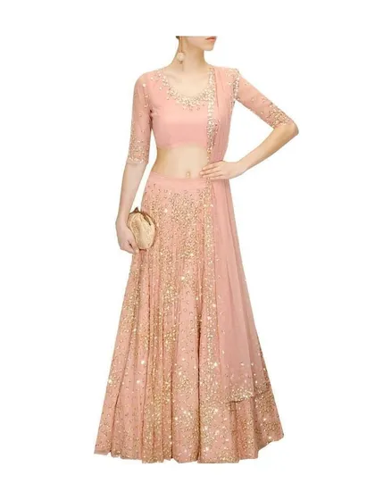 This light pink occasion wear lehenga is detailed with delicate gold sequin work. I work with you to select the right amount of embellishment, ensuring the final outfit matches the event and your personal taste.