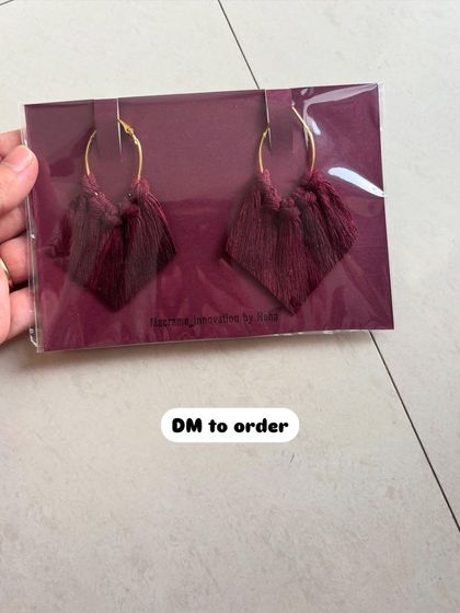 A pair of deep wine-colored macrame earrings. This color is so rich and perfect for an evening look.