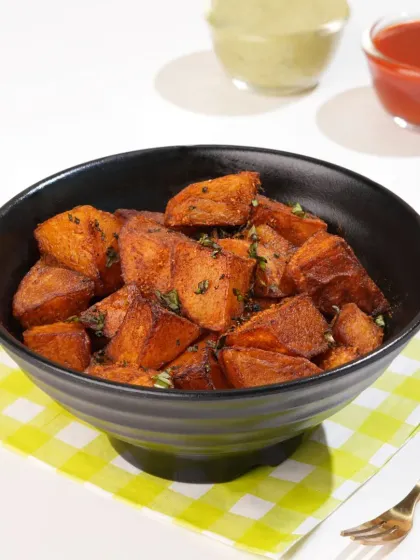 A simple bowl of spiced potatoes, styled to look like a satisfying and flavorful snack. Clean lighting and simple propping ensure the food itself is the hero.