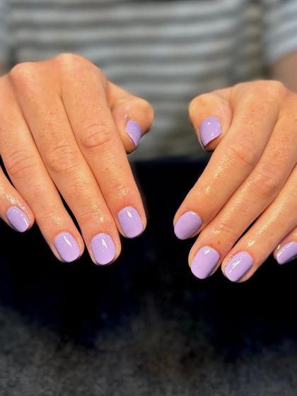 A full view of the pastel lavender gel polish on natural nails. A perfect example of a clean, simple, and chic manicure.