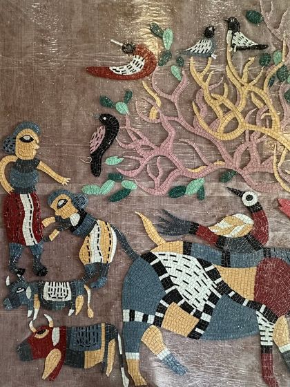 This section of the mosaic introduces human figures and cattle, expanding the story of the forest scene.