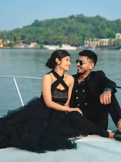 Your love story deserves an adventure. We plan exclusive destination photoshoots, like this luxury yacht session in Goa, to capture your bond against stunning sea views for a truly glamorous experience.