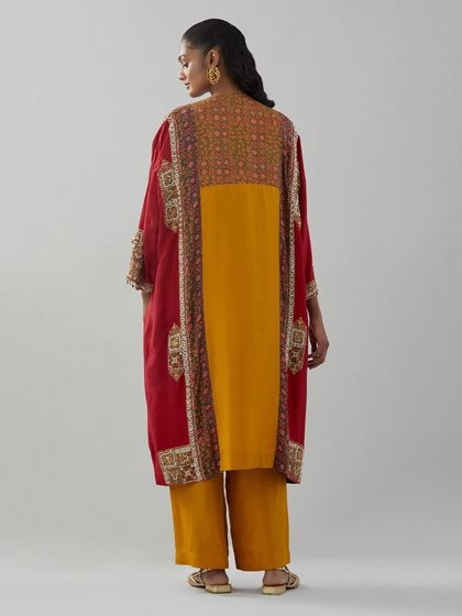 The back view of a layered kurta, combining a vibrant yellow base with a red embroidered overlay for a bold, festive statement.